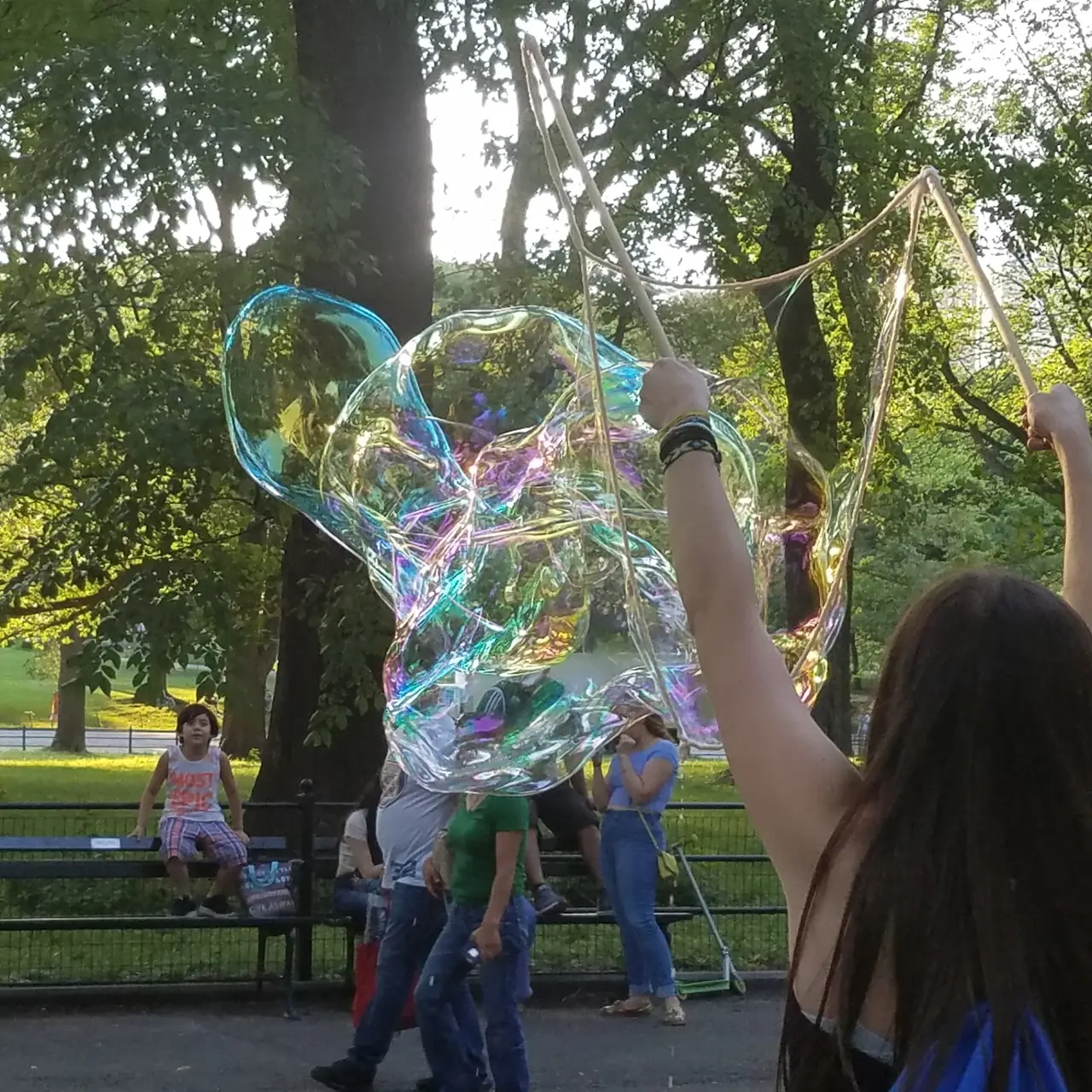 Close-up of an iridescent sculptural bubble in a park