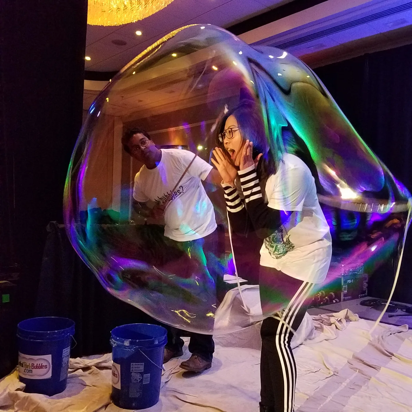Guest standing inside a giant bubble at an indoor party in New York City